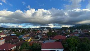 a view of a town under a cloudy sky at Toraja Lodge Guest House in Rantepao