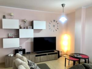a living room with a flat screen tv on a wall at Vivalidays - Estrella de Mar - Calella in Calella