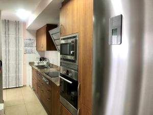 a kitchen with a stainless steel stove top oven at Vivalidays - Estrella de Mar - Calella in Calella