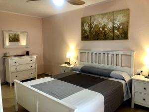 a bedroom with a bed with two night stands and two lamps at Vivalidays - Estrella de Mar - Calella in Calella