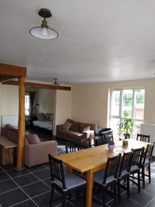 a living room with a wooden table and chairs at den overkant in Diksmuide +24 photos