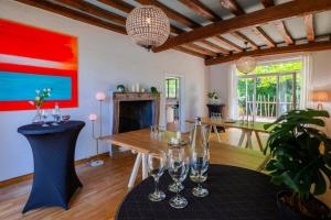 a living room with a table and wine glasses at Villa de La Plume in Nantes