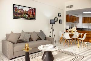 a living room with a couch and a table at Al Hamra Village Marina Residences in Ras al Khaimah