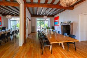 a large dining room with a large wooden table and chairs at Villa de La Plume in Nantes