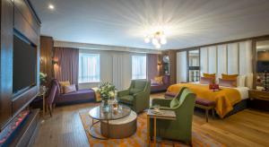 a hotel room with a bed and a television at Glenroyal Hotel in Maynooth