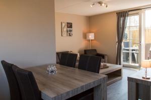 a dining room with a wooden table and chairs at Vakantiewoning aan Zee in Zoutelande