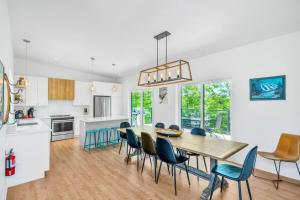a kitchen and dining room with a table and chairs at Wellness Retreat in the Tremblant Area in La Conception