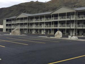 an empty parking lot in front of a hotel at Yellowstone Big Rock Inn in Gardiner