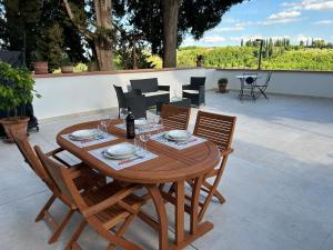 a wooden table and chairs on a patio at La Casa di Nena - San Miniato in San Miniato