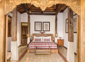 a bedroom with a bed and a wooden ceiling at The Joglo at Umah Sunset in Ubud +31 photos