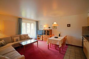 a living room with a couch and a table at Chalet Miravalle 2 in Wengen