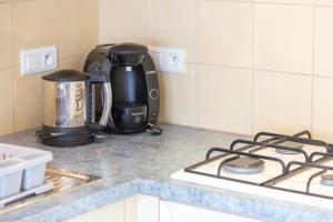 a kitchen counter with a coffee maker and a stove at Maisonette face à la mer in Trébérouant