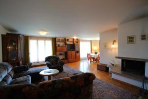 a living room with a couch and a fireplace at Chalet Miravalle 3 in Wengen
