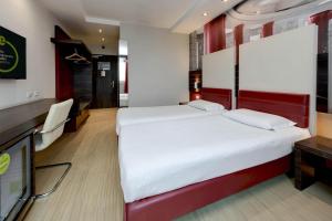 Postel nebo postele na pokoji v ubytování B&B Hotel Trento