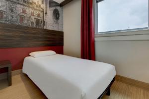 Postel nebo postele na pokoji v ubytování B&B Hotel Trento