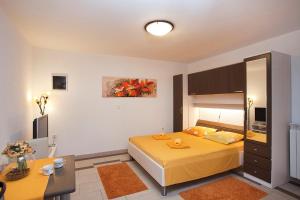 a bedroom with a large yellow bed in a room at Apartments Bellistra Labin in Labin