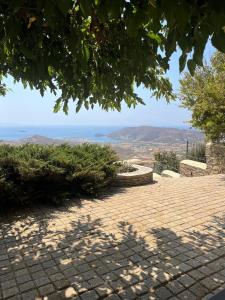 a brick walkway with a view of the ocean at Anastasia Luxury Villas in Gavrio