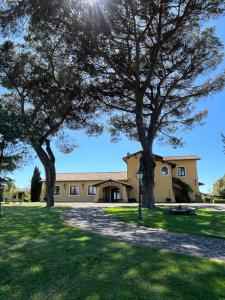 a house with two trees in front of it at Casale Antica Cassia Beauty Spa in Rome
