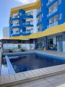 a building with a swimming pool in front of a building at BAHIA FLAT Apt 222 in Salvador