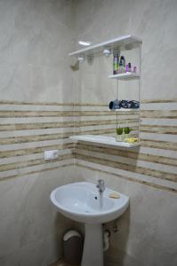 a bathroom with a white sink in a room at NIDA Apartment in Ulcinj +11 photos