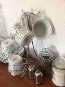 a table with a tea kettle and cups on it at NIDA Apartment in Ulcinj