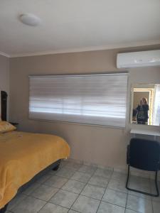 a bedroom with a window with a window blind at House at Bethesda in Springs