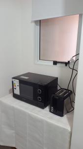 a microwave sitting on top of a table at Moreno924 in Barraquero +9 photos
