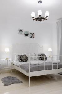 Ένα ή περισσότερα κρεβάτια σε δωμάτιο στο La Maison Blanche