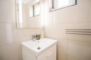 a white bathroom with a sink and a mirror at Casa Foros de Amora in Amora +34 photos