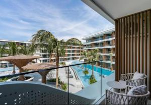 a balcony with a swimming pool and a resort at Sunshine Beach Residence Resort in Phuket Town
