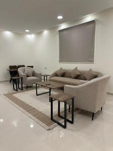 a living room with a couch and a table at شقق فايا in Unayzah