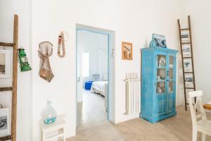 a room with a blue cabinet and a bedroom at La dimora del pescatore in Porto Cesareo +14 photos