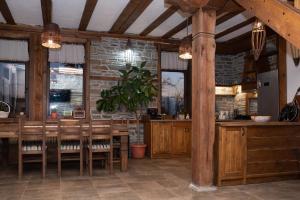 a restaurant with a table and chairs and a brick wall at Къщата на музиканта in Leshten