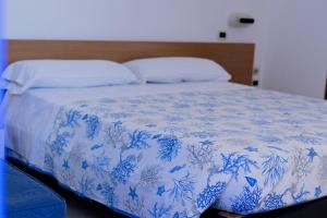 Postel nebo postele na pokoji v ubytování Hotel Stella del Tirreno