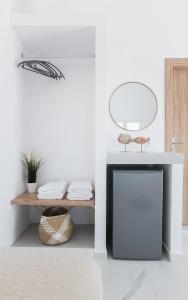 a living room with a fireplace and a table at Kýma Perissa in Perissa +49 photos