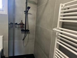 a shower with a shower head in a bathroom at Le logis de Keramporchet - Proche plages in PloÃ©ven +16 photos
