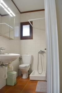 a bathroom with a sink and a toilet and a shower at Aegean Bliss Residences - Karfas in Karfas +39 photos