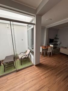 a living room with a view of a room with a table at Ravenala - Apartment Paracas in Paracas
