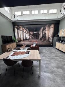 a room with a table and chairs and a large window at L'entrepôt in Auxerre +12 photos