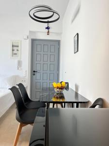 a dining room with a table and two chairs at Aeolian Breeze 3 in Tinos