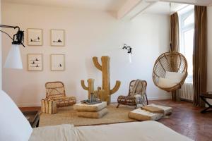 a living room with cactus chairs and a bed at La Chaumière in Honfleur +57 photos