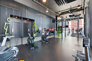 a gym with treadmills and exercise bikes in it at Plateau Zen & Cosy in Gatineau
