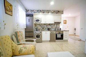 a kitchen with a couch and a stove top oven at apartamento privado en un chalet 3 in L’Alfàs del Pi