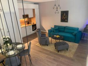 a living room with a blue couch and a table at Marigold Premium in Novi Sad