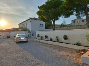a car parked in a driveway in front of a house at Zen et cosy in Marseille