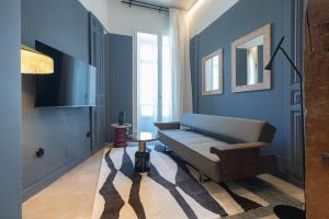 a blue living room with a couch and a table at Marino Marina - Unique & Exclusive Stay - Prime Location in Málaga