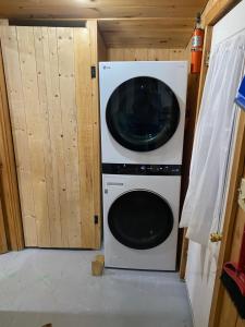 a washer and dryer in a tiny house at Riverfront Rustic Cottage in Durham Bridge