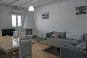 a living room with a couch and a table at Villa & Suite Elia Mykonos in Mikonos