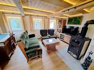 a living room with a fireplace and a stove at Ferienhaus Rita in Bad Bocklet