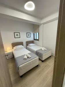 a bedroom with two beds and a mirror at Le Voyageur II in Larnaca
